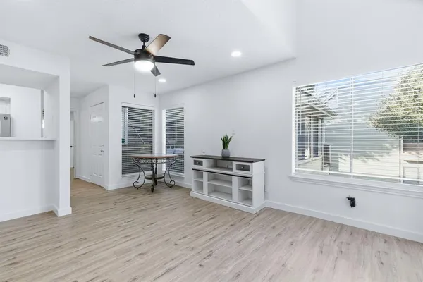 a view of a livingroom with wooden floor and a window