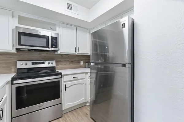 a kitchen with a stove microwave and refrigerator