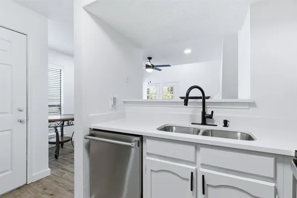 a kitchen with a sink and a refrigerator