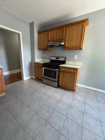 a kitchen with stainless steel appliances a stove a sink and a microwave