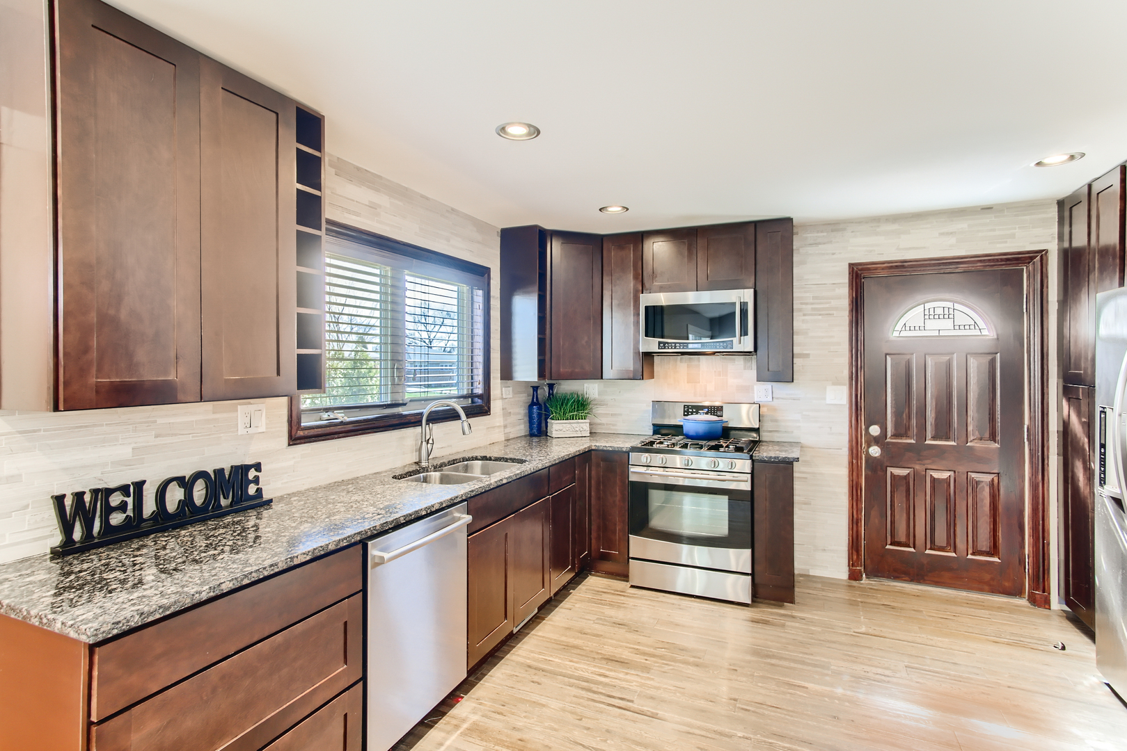 100 Highview Avenue Addison, IL 60101 - Photo 5 of 28 a kitchen with stainless steel appliances granite countertop a sink stove and refrigerator