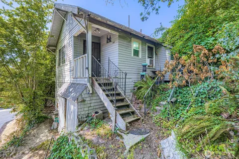 a front view of a house with a garden