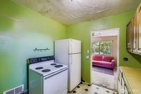 a kitchen that has a sink and a refrigerator