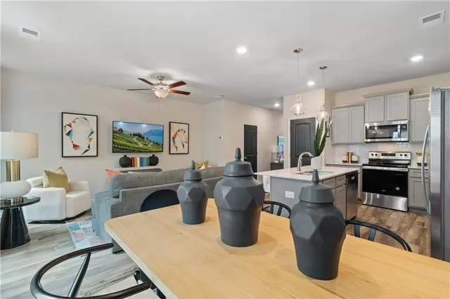 a living room with furniture a window and kitchen view