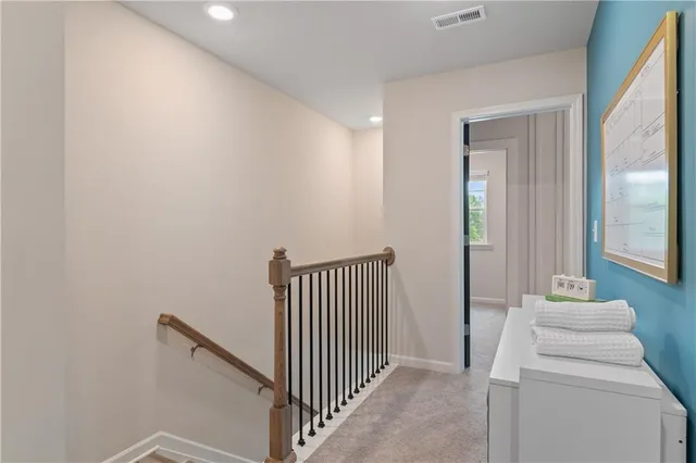 a view of a hallway with workspace and a bathroom