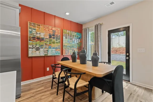 a view of a dining room with furniture window and wooden floor