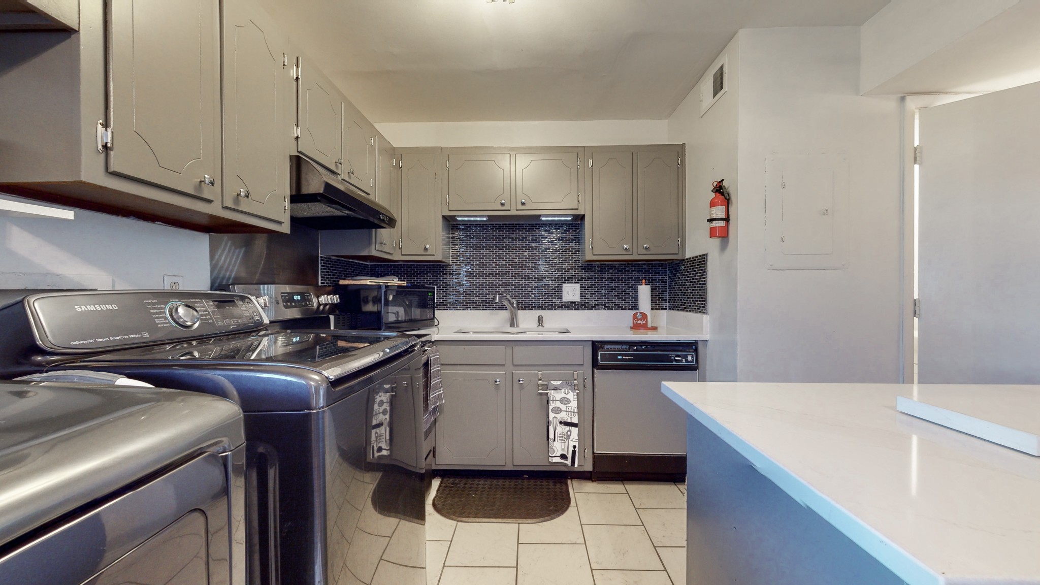 370 Wallace Road, Unit G3 Nashville, TN 37211 - Photo 11 of 30 a kitchen with stainless steel appliances granite countertop a sink stove and cabinets