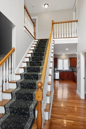 a view of entryway and hall with wooden floor