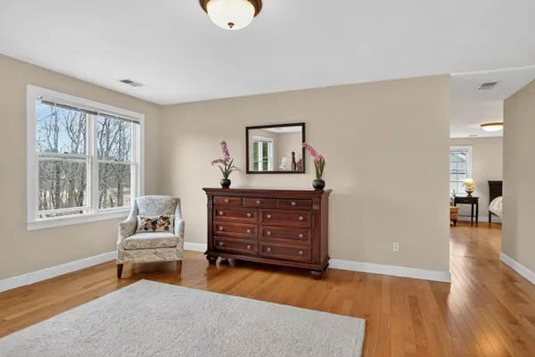 a living room with furniture and wooden floor