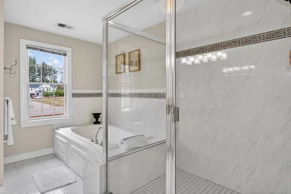 a bathroom with a bathtub and shower