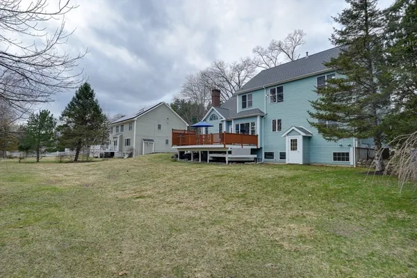 a front view of a house with a garden and trees