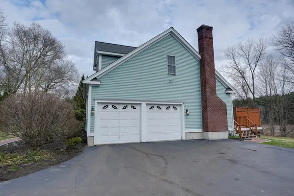 a view of a house with a yard and garage