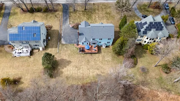 a aerial view of a house with a yard and sitting area