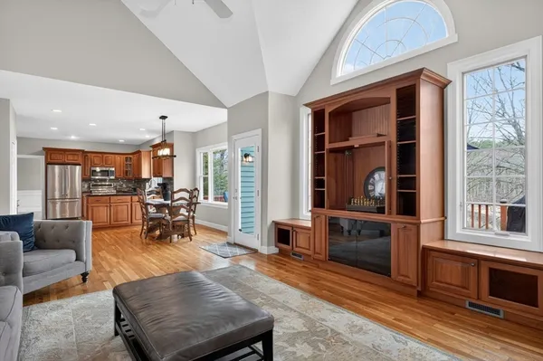 a living room with furniture a window and mirrors