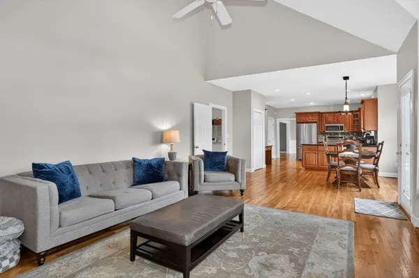 a living room with furniture and a view of kitchen
