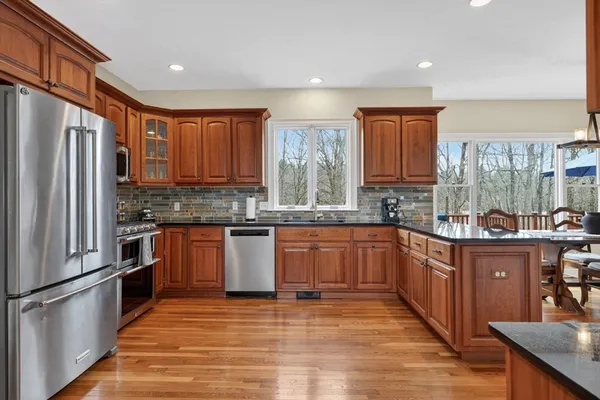 a kitchen with stainless steel appliances granite countertop a refrigerator sink and cabinets