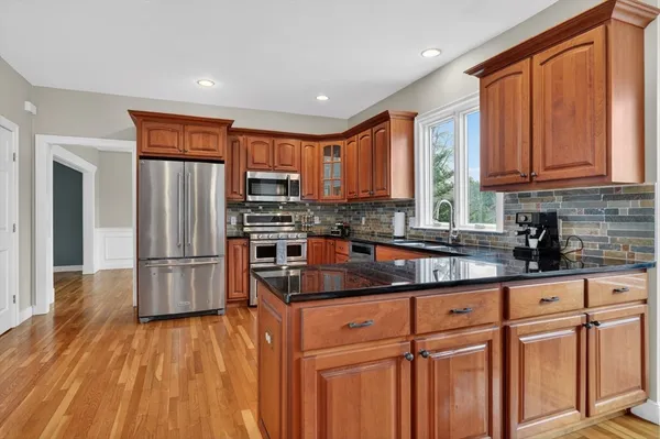 a kitchen with stainless steel appliances granite countertop a refrigerator sink and cabinets