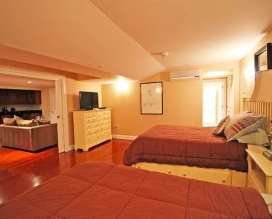a bedroom with a bed and a view of kitchen