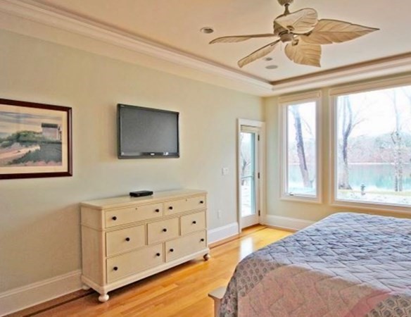 385 Barnes Road Oak Bluffs, MA 02557 - Photo 14 of 29 a bedroom with a bed dresser and wooden floor
