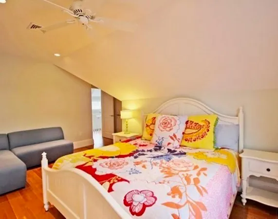 a bedroom with a bed and lamp