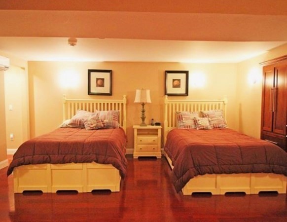 385 Barnes Road Oak Bluffs, MA 02557 - Photo 18 of 29 a bedroom with two beds and painting on the wall
