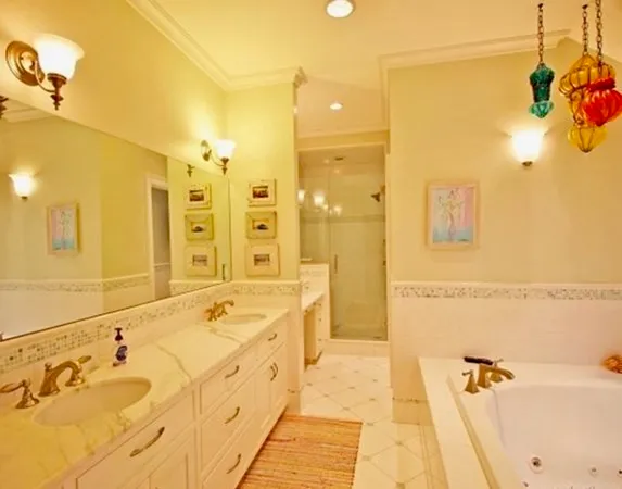 a spacious bathroom with a tub sink and mirror