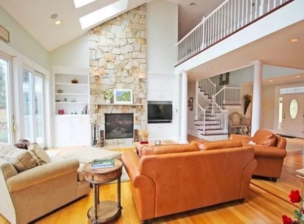 a living room with furniture wooden floor and a flat screen tv