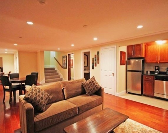 385 Barnes Road Oak Bluffs, MA 02557 - Photo 5 of 29 a living room with furniture kitchen view and a wooden floor