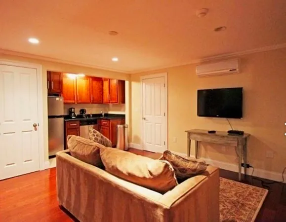 a living room with furniture and a flat screen tv