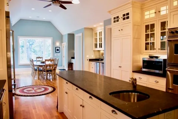 a kitchen with stainless steel appliances granite countertop a sink a stove and a refrigerator