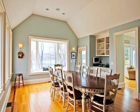 a dining room with furniture and wooden floor