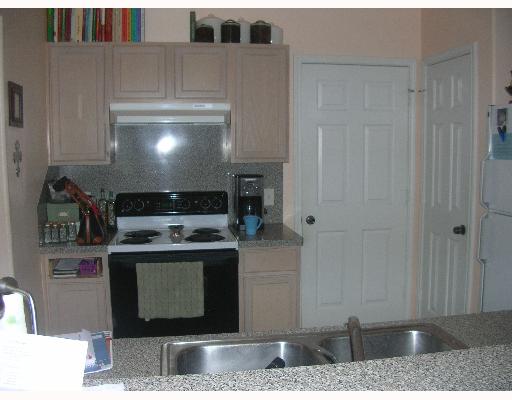 15530 Cruiser Street Corpus Christi, TX 78418 - Photo 3 of 4 a kitchen with stainless steel appliances granite countertop a stove and a cabinets