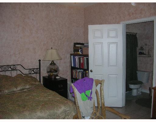 15530 Cruiser Street Corpus Christi, TX 78418 - Photo 4 of 4 a bedroom with a bed and a book shelf