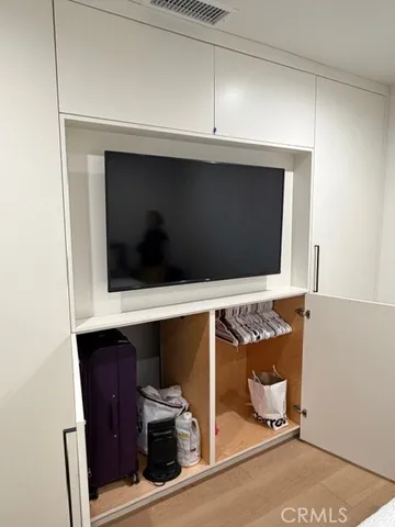 a living room with a fireplace and a flat screen tv