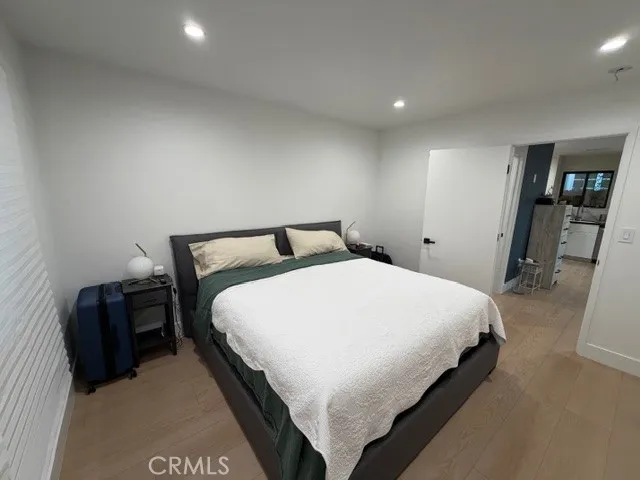 a bedroom with a bed and a night stand