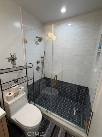 a bathroom with a toilet a sink and shower