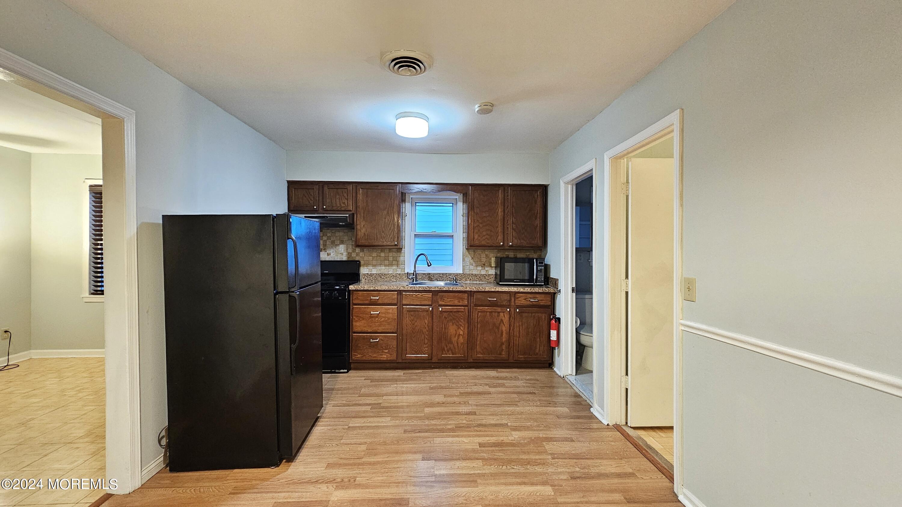 511 Bay Avenue, Unit 2 Point Pleasant Beach, NJ 08742 - Photo 1 of 13 a kitchen with stainless steel appliances a refrigerator and a sink