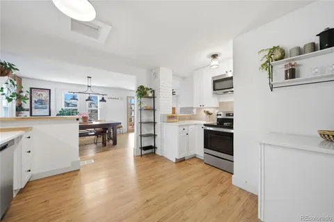 a kitchen with stainless steel appliances a stove refrigerator sink and cabinets