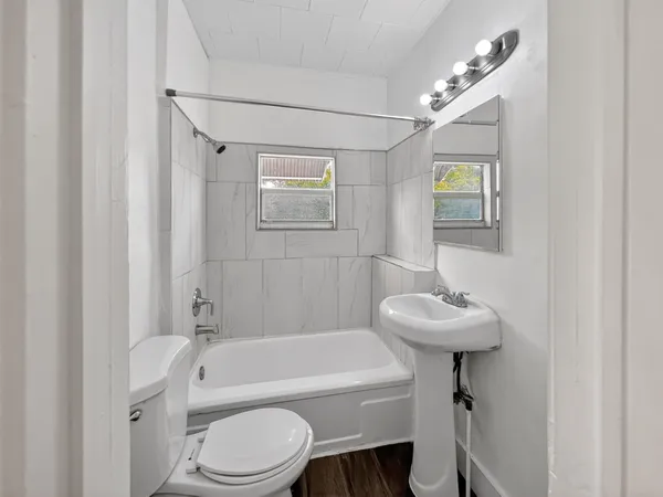 a bathroom with a sink a toilet and bathtub