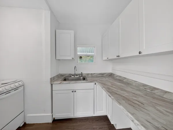 a kitchen with stainless steel appliances granite countertop a sink and cabinets