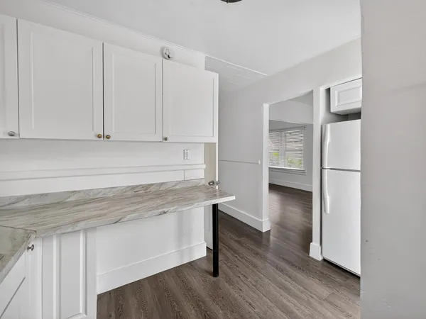 a kitchen with stainless steel appliances granite countertop a sink a stove and a refrigerator