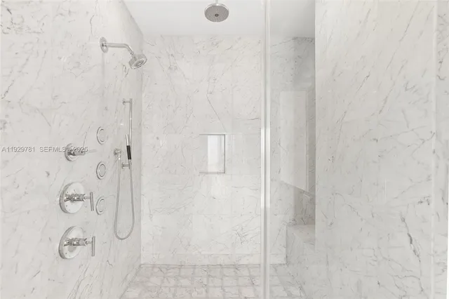 a living room with furniture and large windows