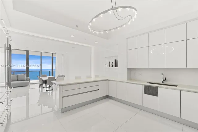 a kitchen with white cabinets and white appliances