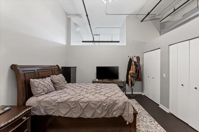 a bedroom with bed and a window