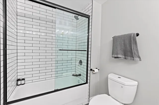 a bathroom with a shower and a toilet
