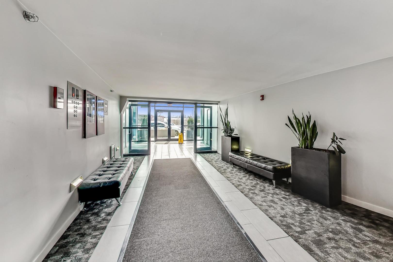 1224 West Van Buren Street, Unit 304 Chicago, IL 60607 - Photo 27 of 29 a bed room with a bed and a couch