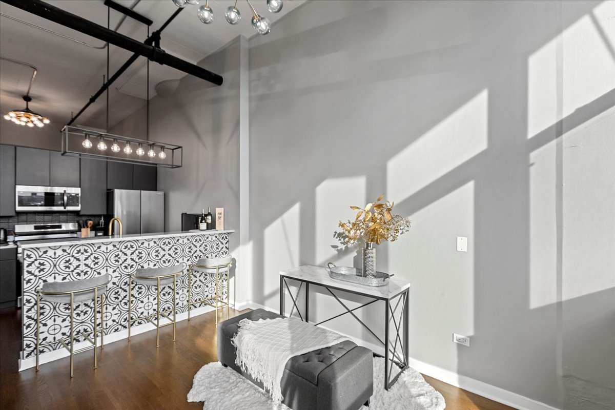 1224 West Van Buren Street, Unit 304 Chicago, IL 60607 - Photo 8 of 29 a living room with furniture and a chandelier