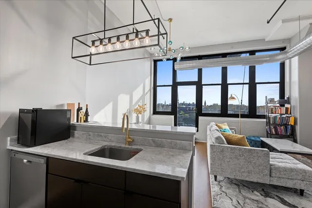 a living room with furniture a flat screen tv and a large window