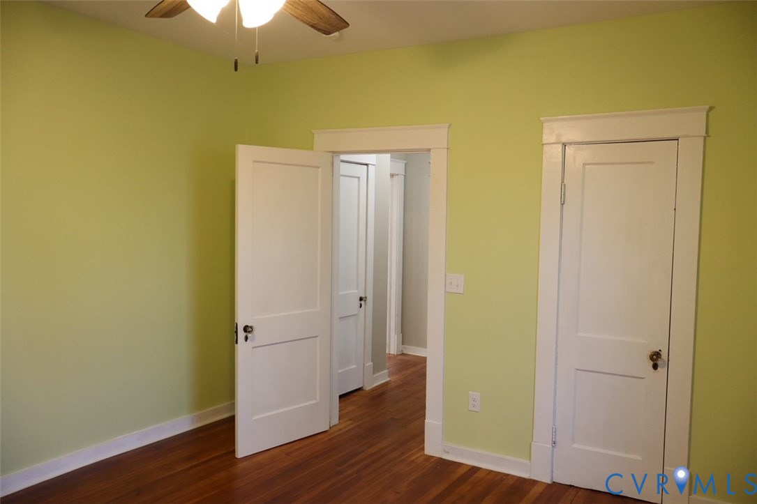 9540 Pridesville Road Amelia Court House, VA 23002 - Photo 12 of 15 an empty room with wooden floor and a ceiling fan