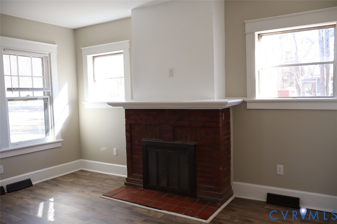 9540 Pridesville Road Amelia Court House, VA 23002 - Photo 9 of 15 an empty room with windows and fireplace